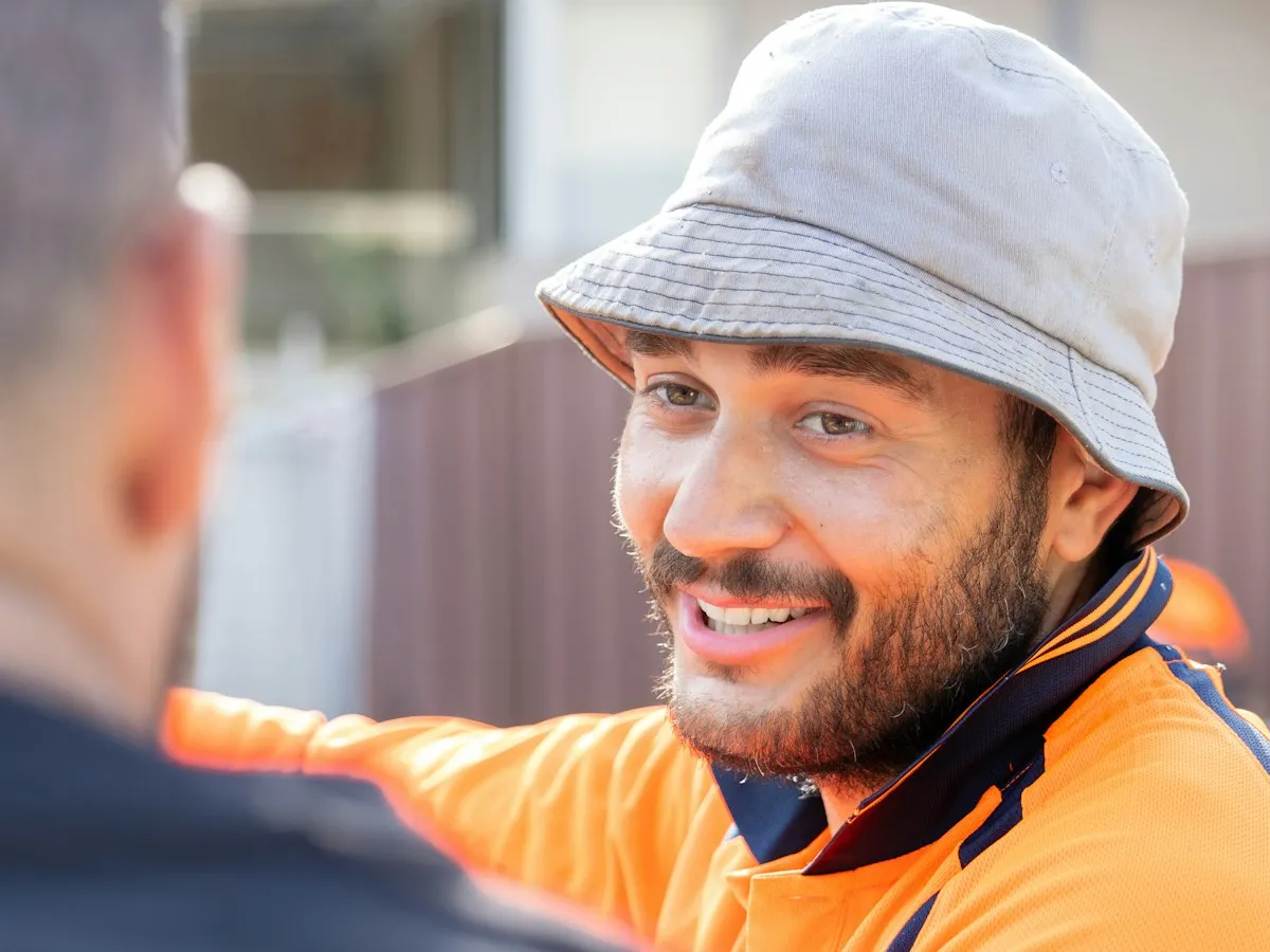 Two tradespeople talking through a job on site.