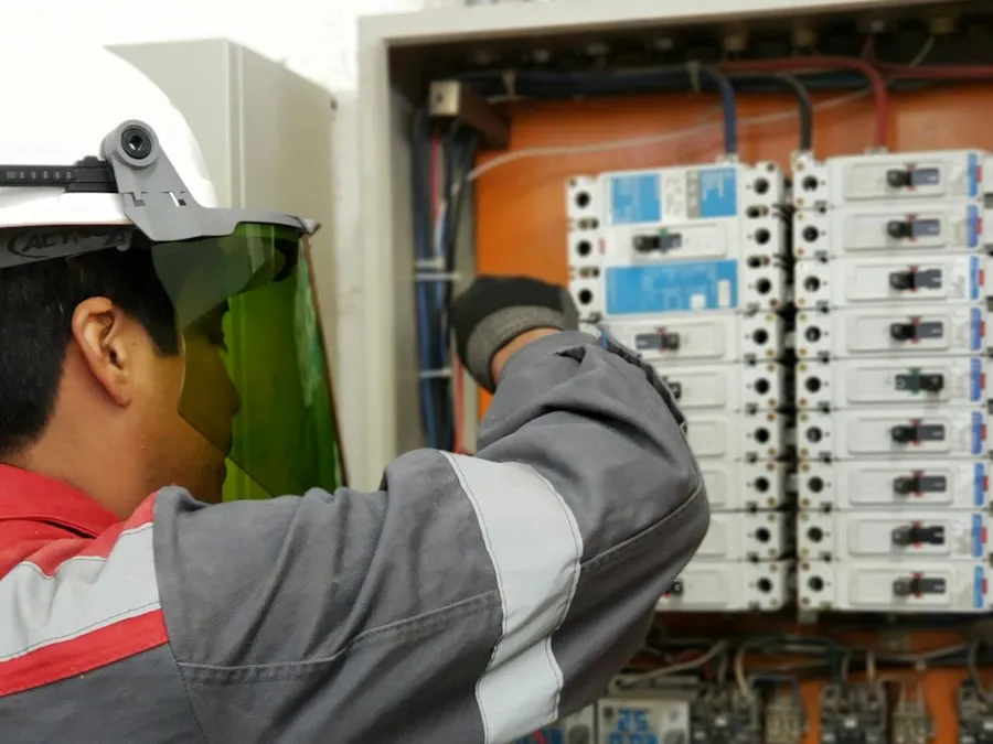 A technician in a hard hat testing equipment.