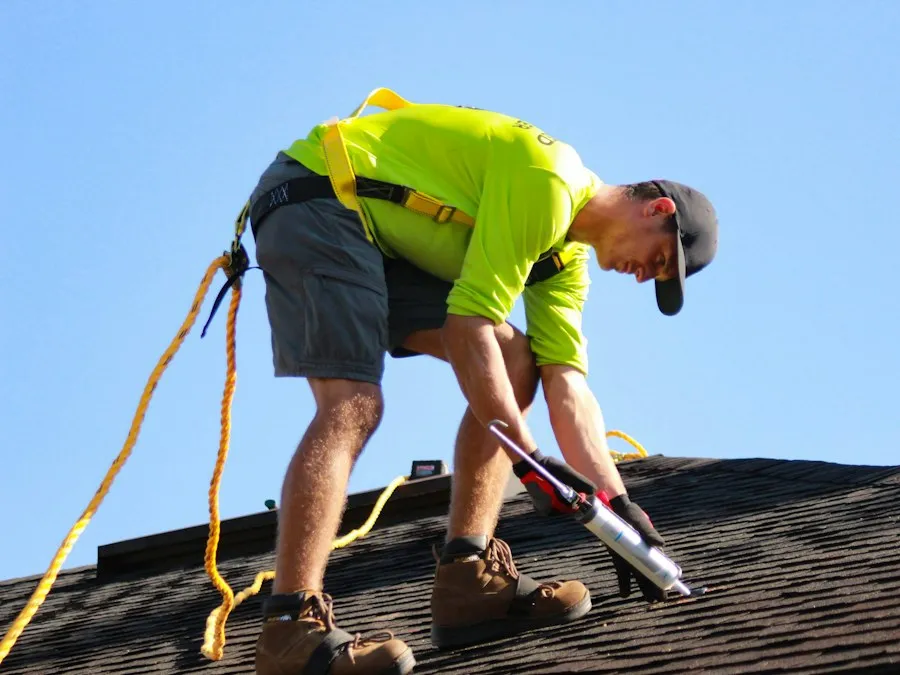 A roofer at work on a pitched roof.